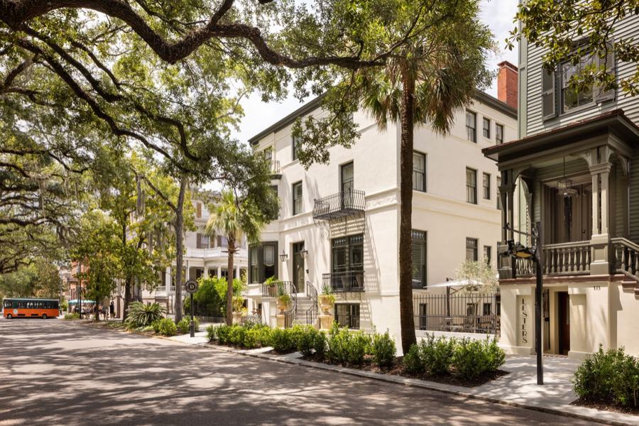 Oglethorpe Avenue under live oaks, a red trolley at the kerb