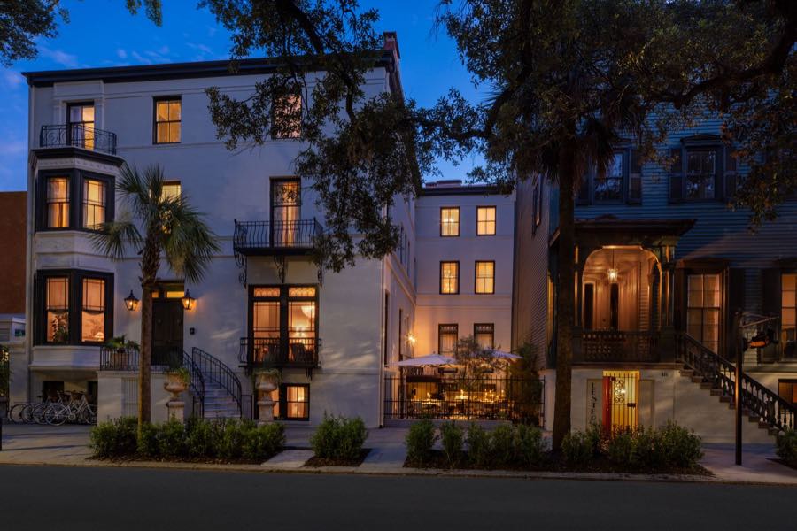 The facade of The Douglas at blue hour, its windows lit