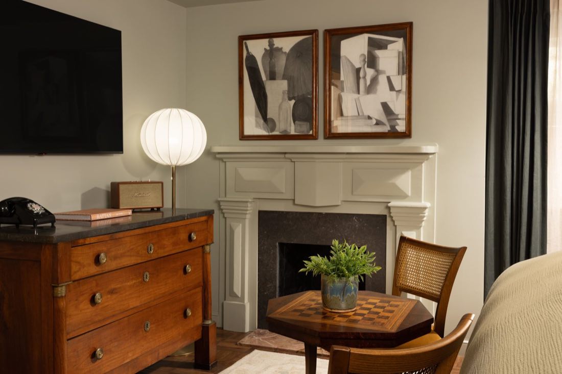 Room Three, a walnut chest beneath a paper globe lamp and two cubist prints.