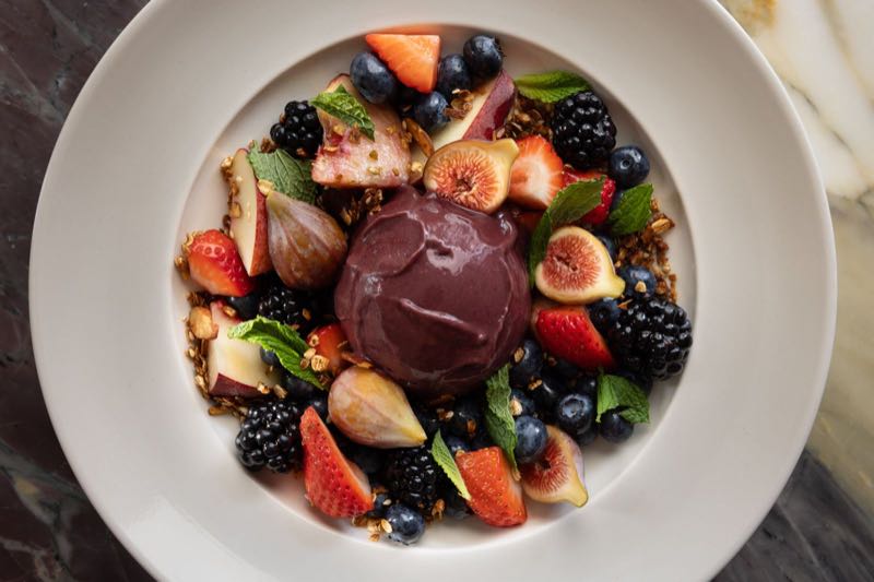 Blueberry acai bowl: a sorbet quenelle with figs, berries, granola and mint
